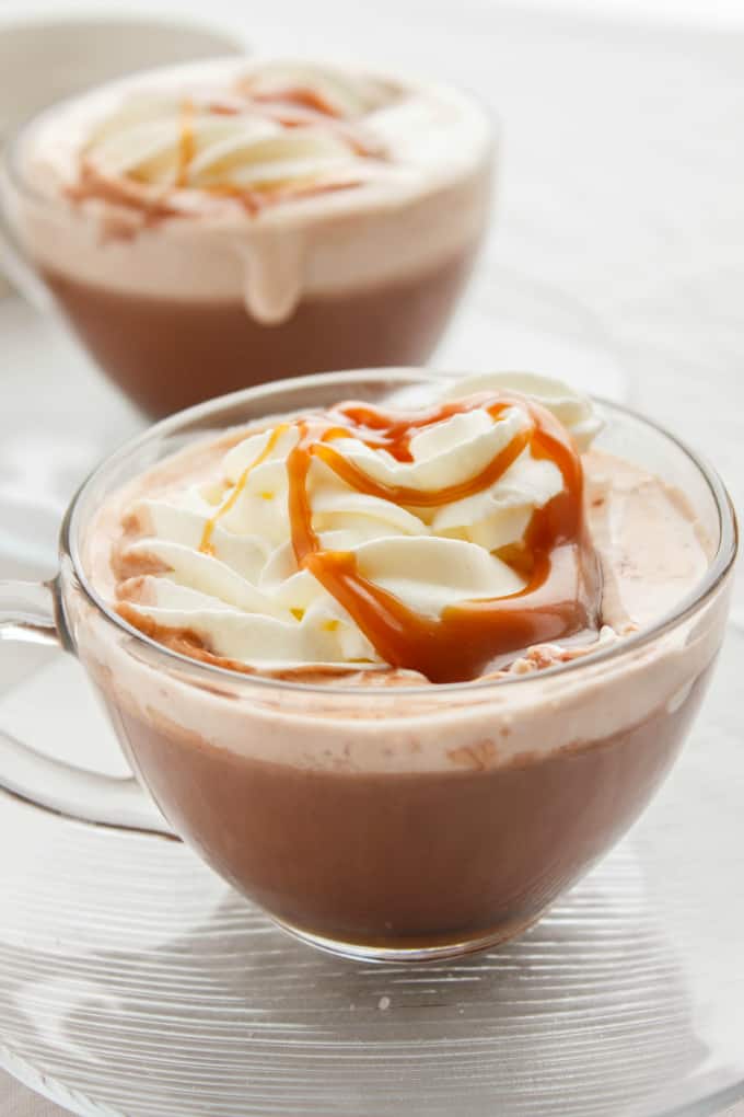 Salted Caramel Hot Cocoa in glass cups on glass plates