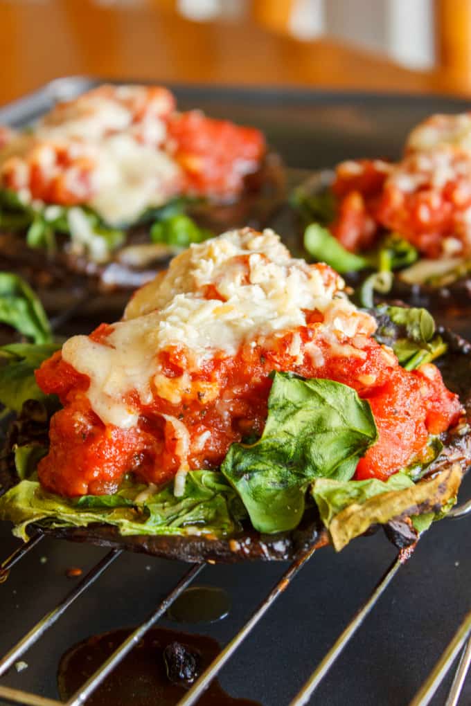 Small portobello mushroom pizzas on baking grid