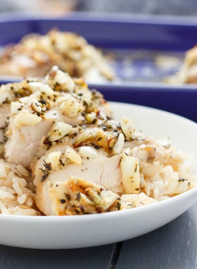 Sweet Garlic Chicken Breasts  on white plate,  purple baking pot in the background#chicken