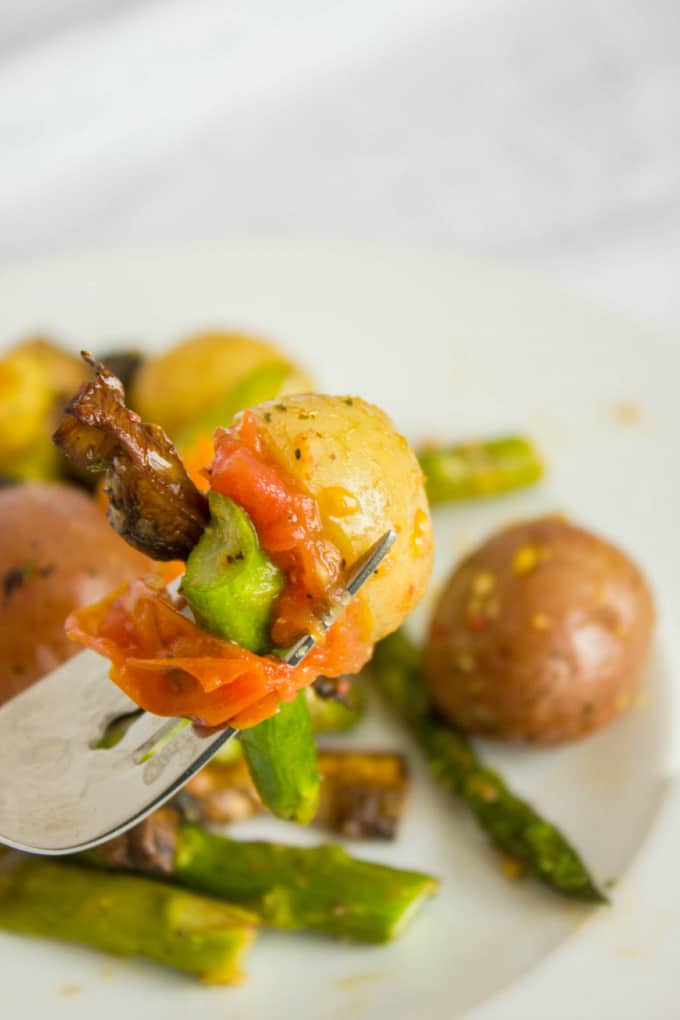 Easy Creamer Potatoes with Roasted Vegetables picked on fork on white plate