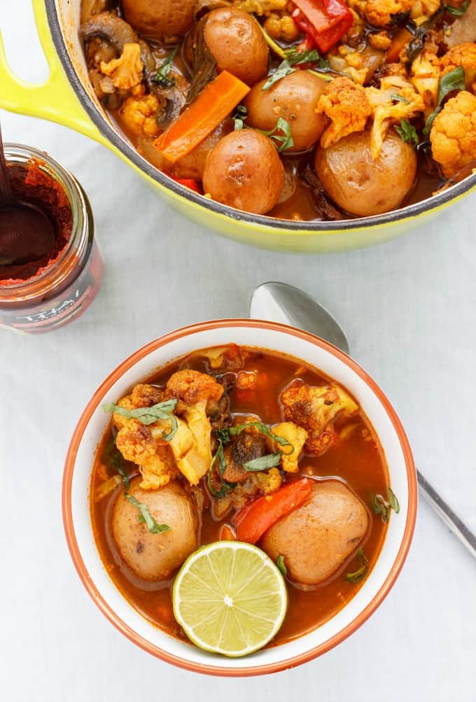 Roasted Vegetable Massaman Curry Soup (in white oragne bowl on white table with spoon and pot with same dish and glass jar (Coconut-Free) #soup