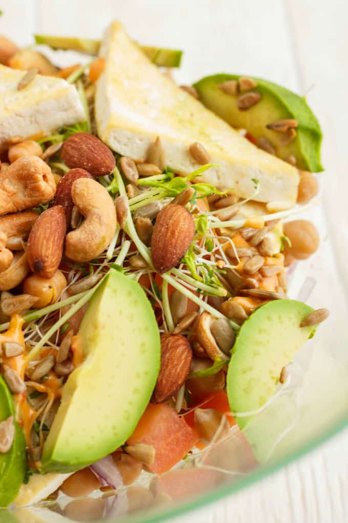 Fresh Powerhouse in glass bowl with veggies, fruits, bread and nuts