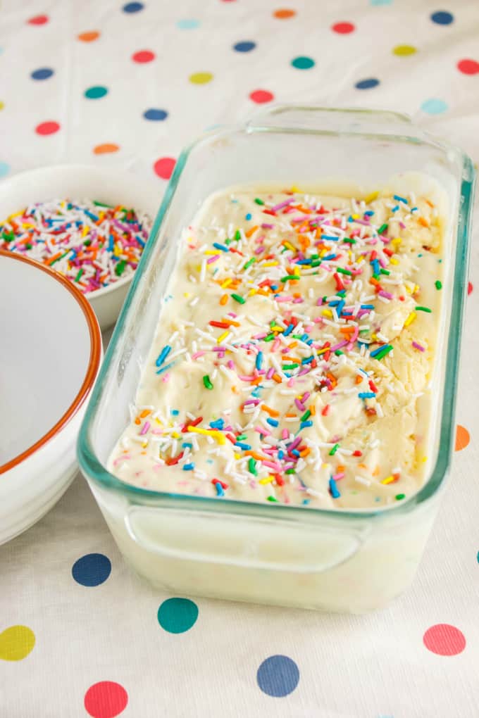 Homemade Birthday Cake Ice Cream in glass container next to bowls