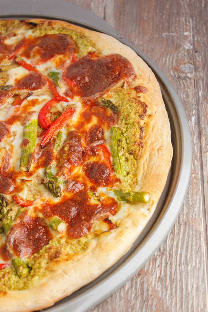 Broccoli pizza on tray on wooden table