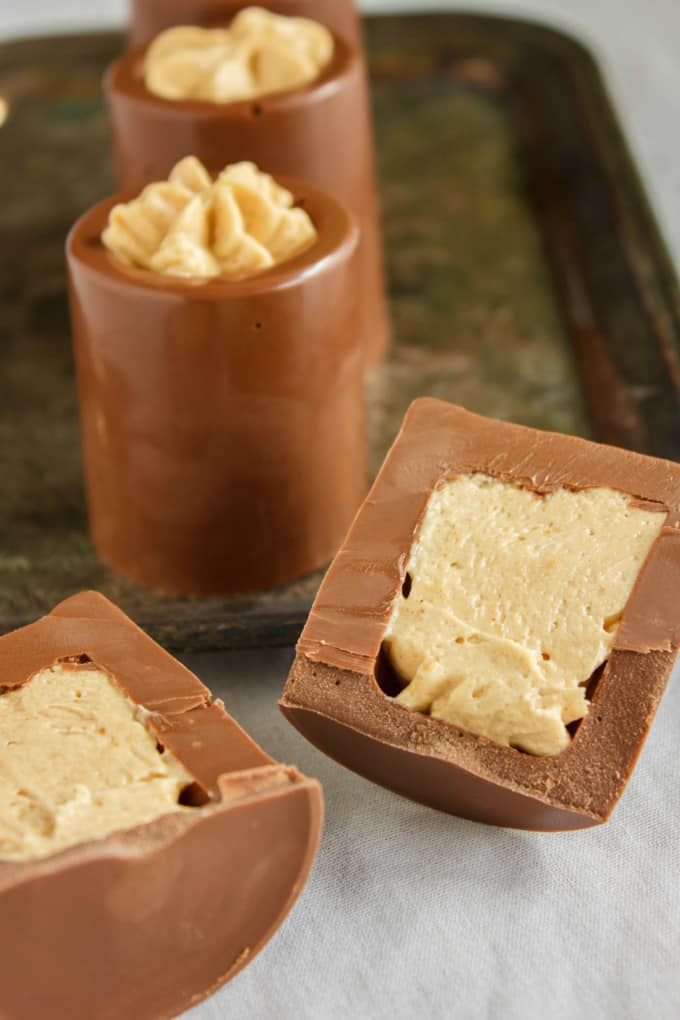 Chocolate Shot Glasses with Peanut Butter Mousse on tray and one shot sliced in half