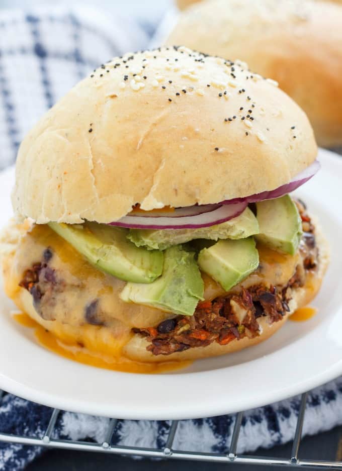 Homemade Hamburger Buns with veggies inbetween on white plate#vegetarian