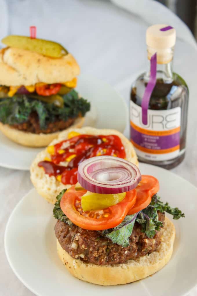 Homemade grill hamburger on white plate, hamburger and bottle in the background