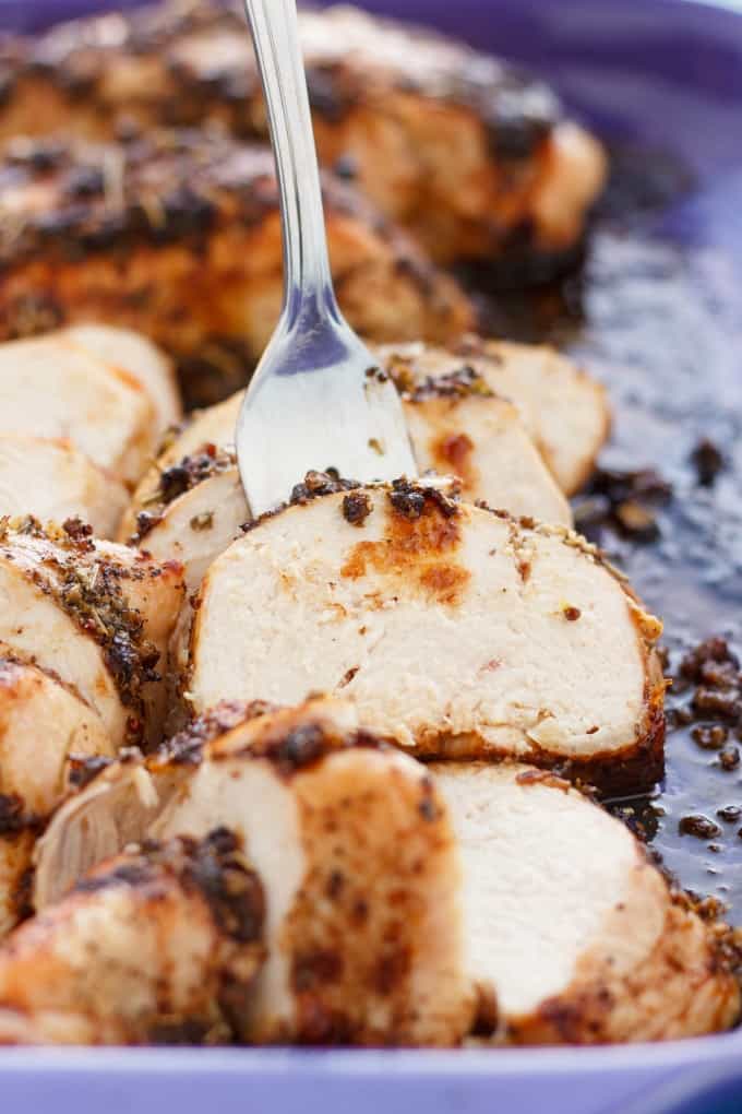 Baked Balsamic Chicken picked by fork on baking pot
