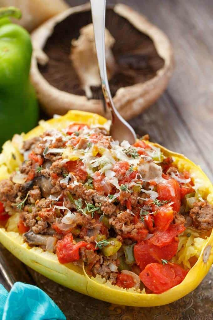 Stuffed Spaghetti Squash with Tomato and Ground Beef with fork on wooden table