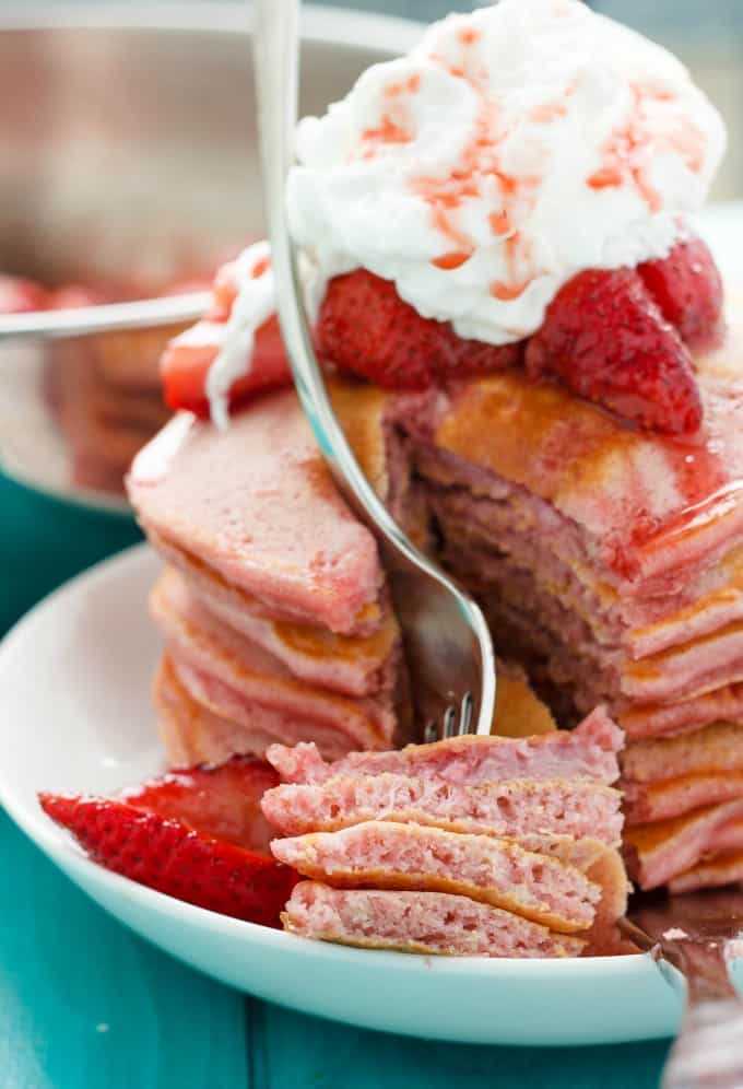 Strawberries and Cream Pancakes on white plate with fork