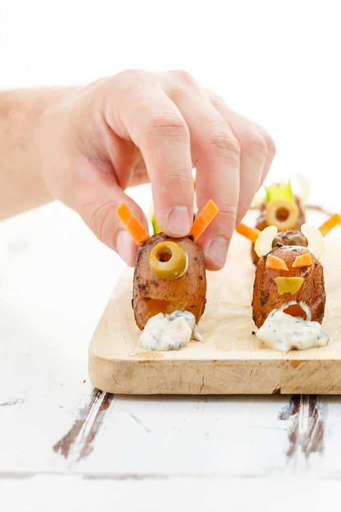 Vomiting Potato Monsters on wooden pad, one held by hand(for Halloween!)