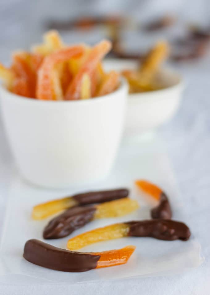Homemade Candied Citrus Peels in white bowls and napkin