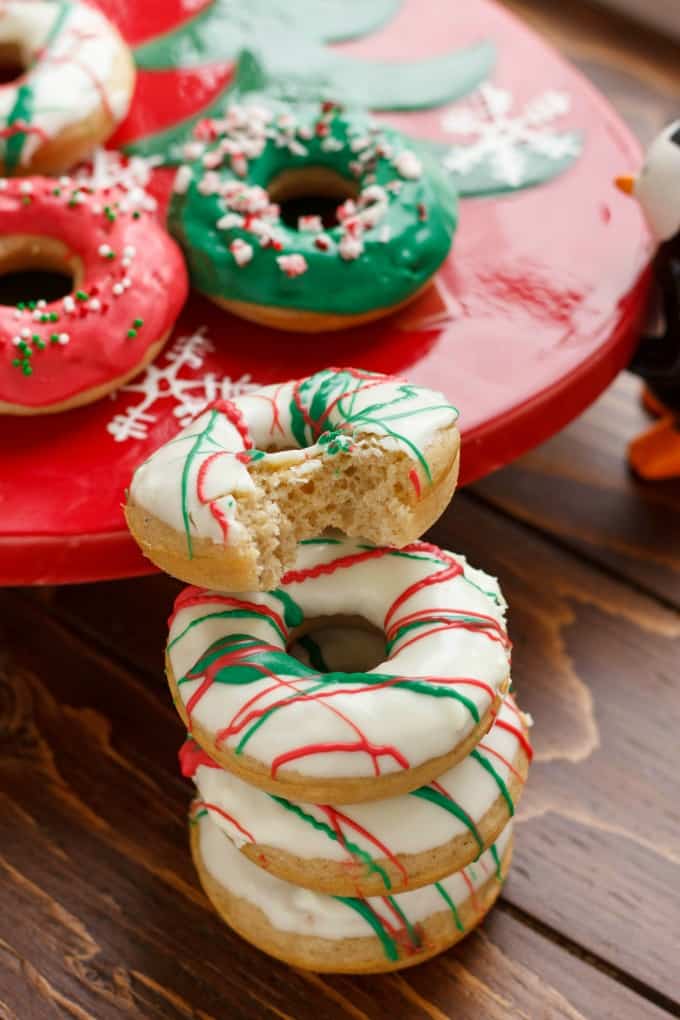 Christmas Doughnuts with Candy Melts Glaze on wooden table and red tray#Christmas