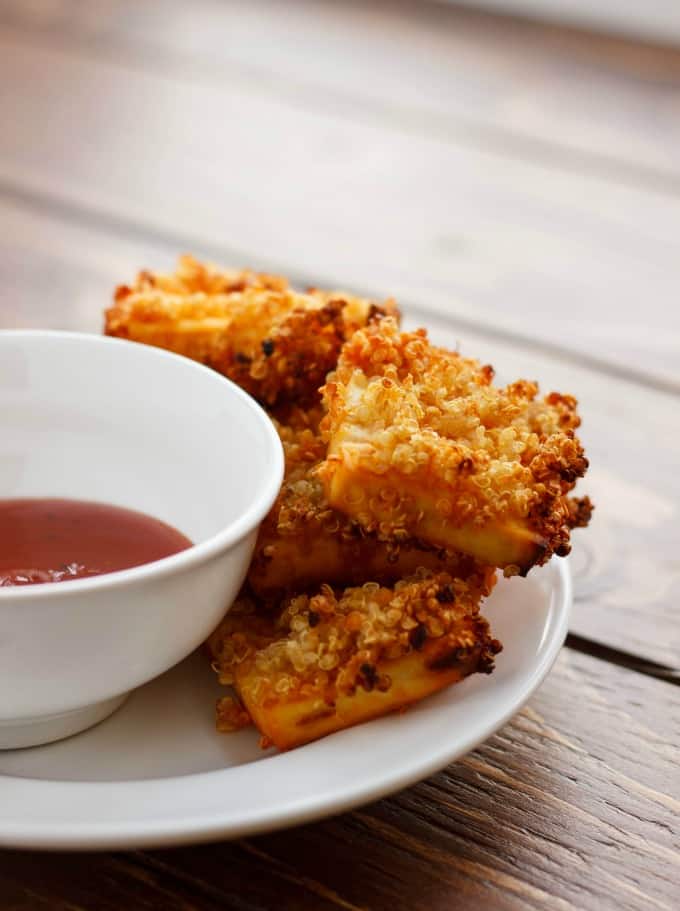 Quinoa Crusted Tofu Nuggets on white plate with dip in white bowl