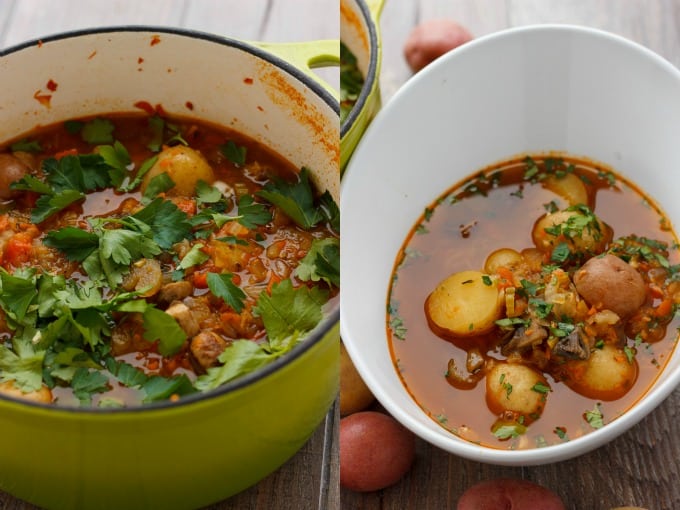 Simple Vegetable Soup with Creamer Potatoes in green cooking pot, soup in white bowl on wooden table with potatoes around