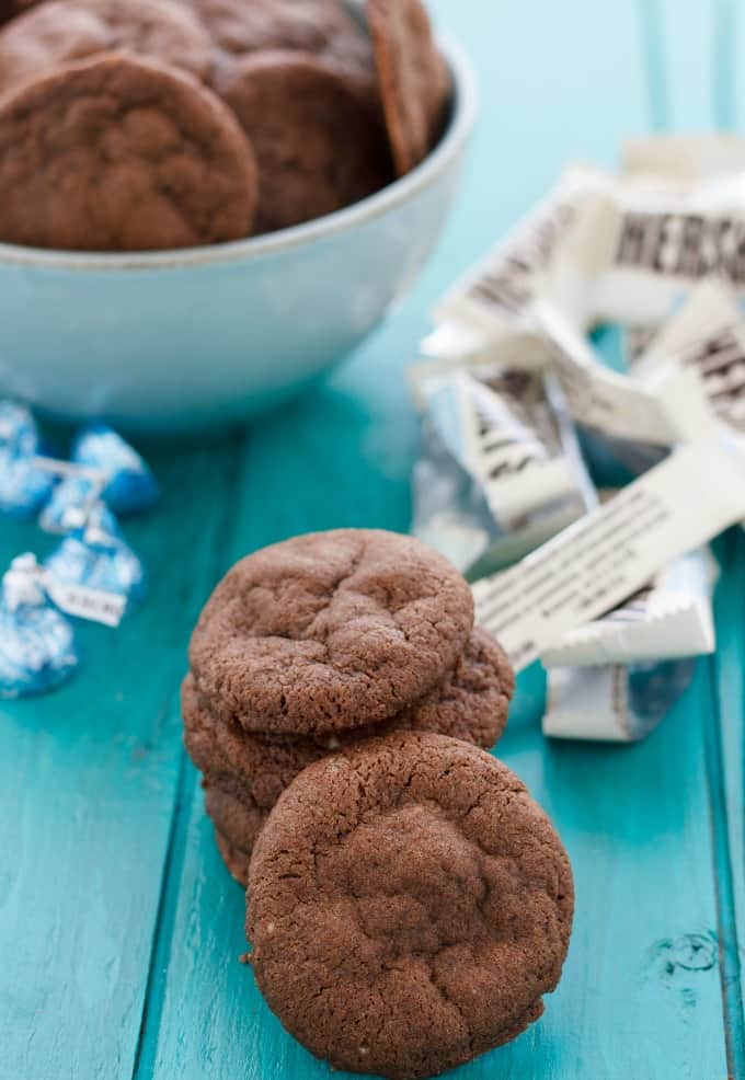  Cream Stuffed Cookies  on blue table and in white bowl, cookies spilled around on table#chocolate