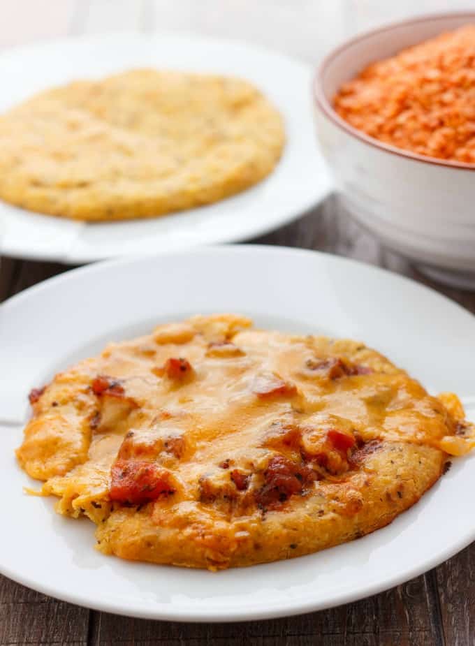 Lentil Pizza Crusts on white plates with bowl full of lentils #pizza