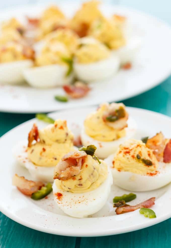 Jalapeno popper deviled eggs on white plates