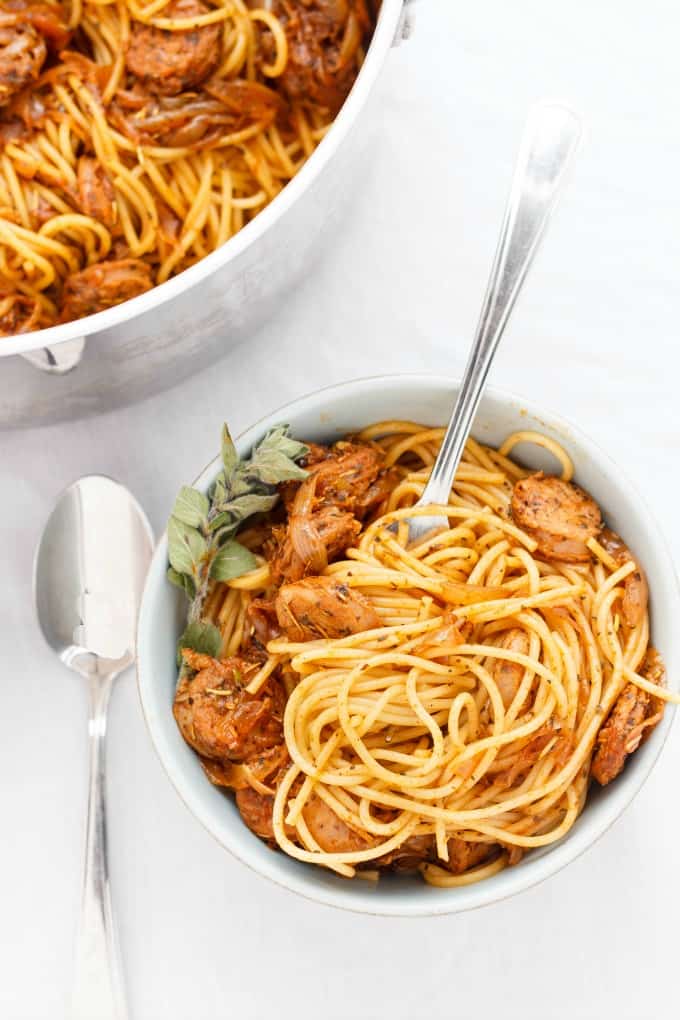 Dry Herb Sausage Spaghetti  in bowl with fork, near spoon on white table#pasta