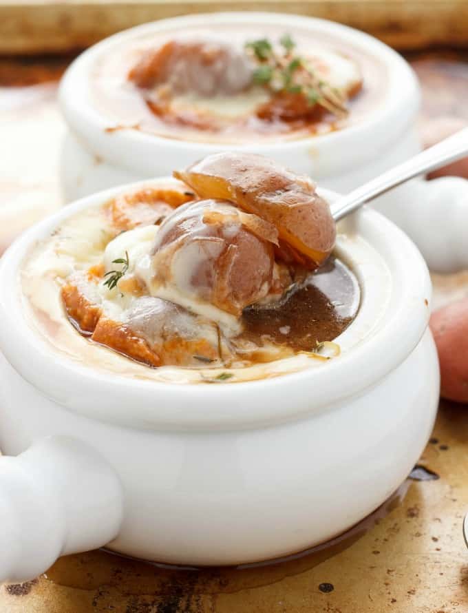 French Onion Soup with Potatoes in white bowls, potatoe picked by spoon#creamerpotatoes