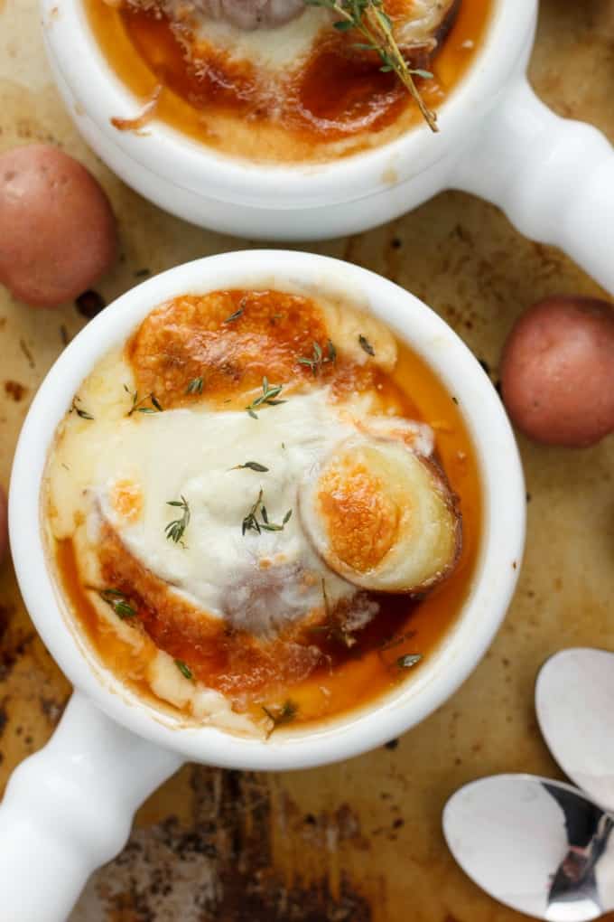 French Onion Soup with Potatoes in white bowls with spoons and potatoes on the table#healthy