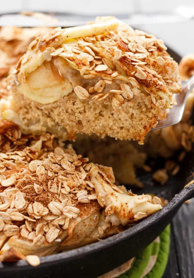 Skillet Apple Cake with Cinnamon Oat Topping on pan picked by spatula