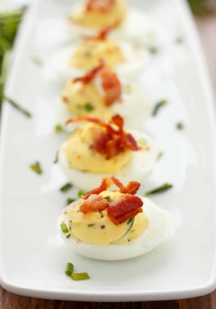 Sour Cream, Chive, and Bacon Deviled Eggs  on white tray#eggs