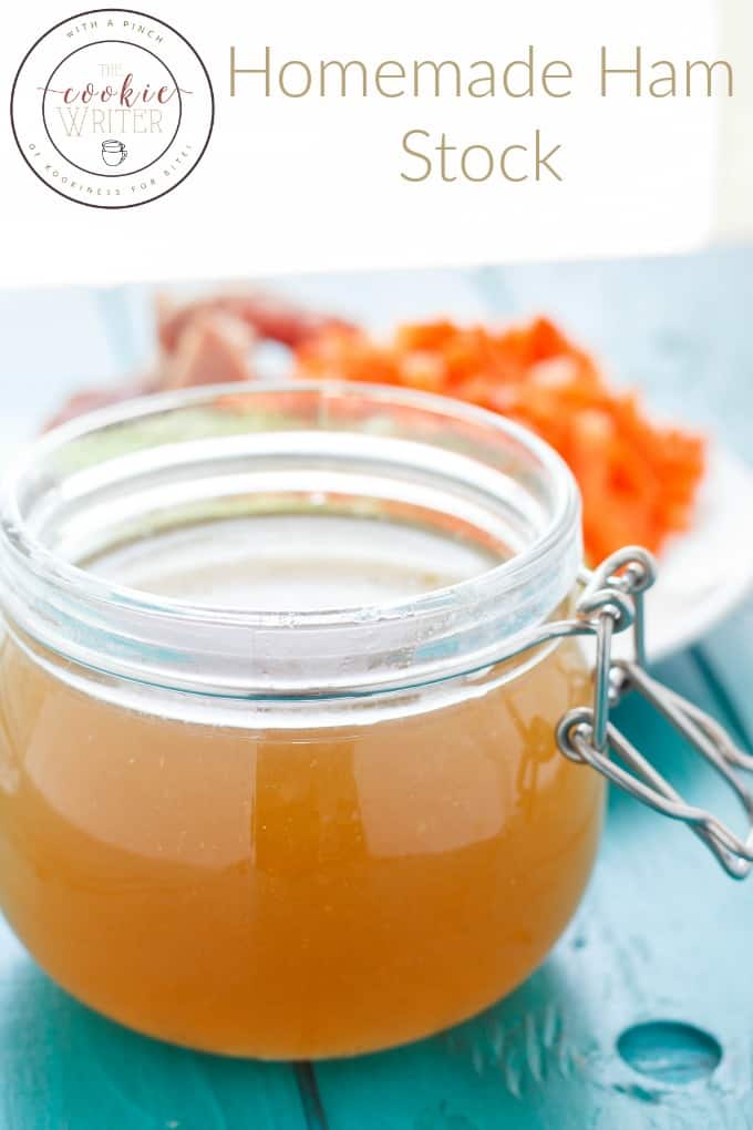 Homemade ham stock in glass jar on blue table, plate of bacon in the background