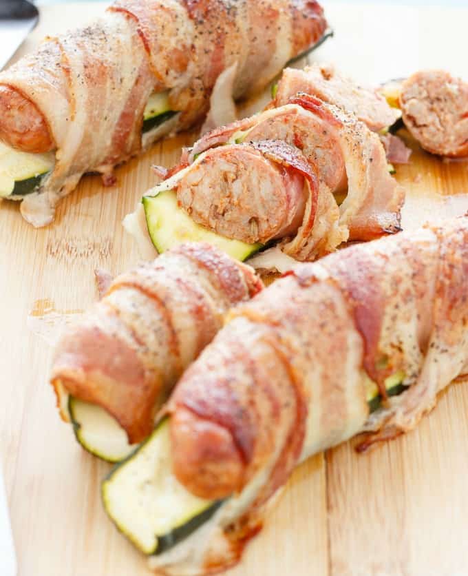 Bacon Wrapped Sausage and Zucchini on wooden pad #bacon