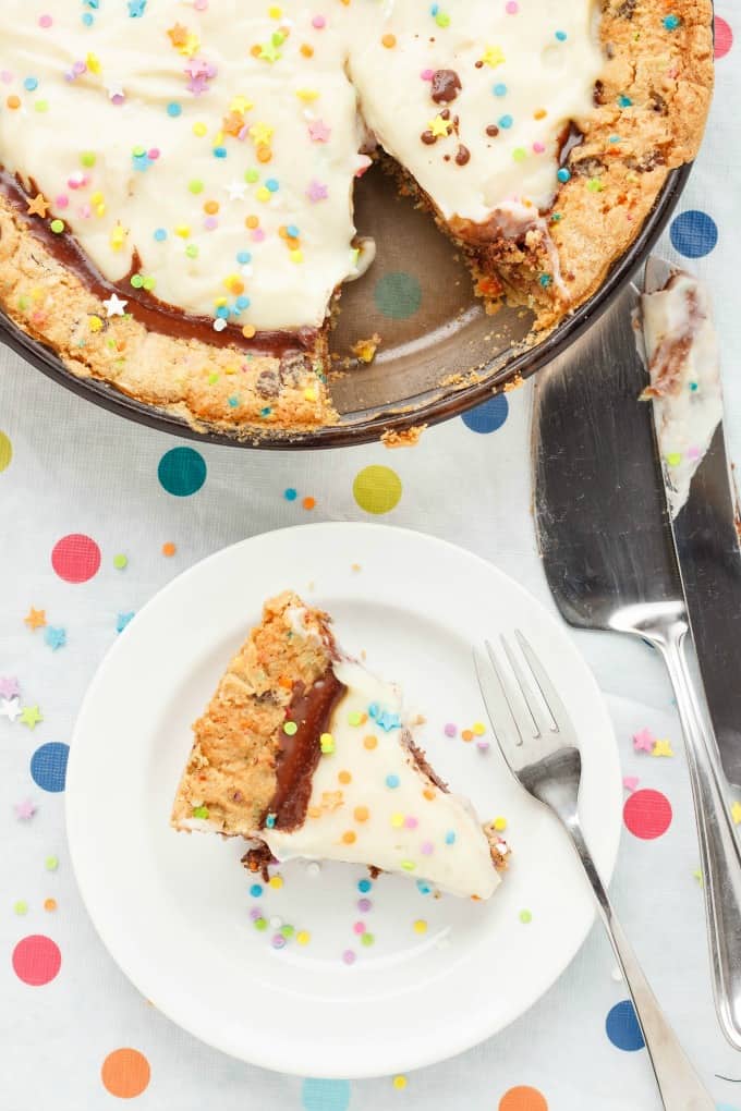 Birthday Cake Cookie and Pudding Pie on traym slice of cake on white plate with fork and pie knife #pie