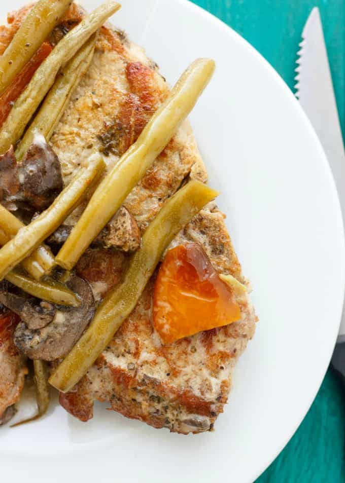 Pork Chops with Green Beans in the Slow Cooker on white plate with knife  #glutenfree