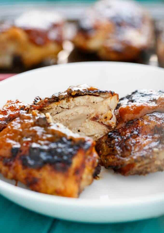 BBQ Chicken Thighs sliced with Rhubarb BBQ Sauce on white plate