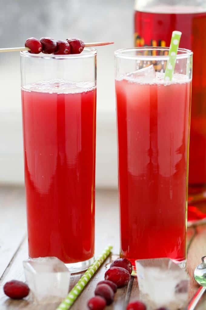 The Sour New Yorker drink in glass cups with straws, ice cubes and raspberries