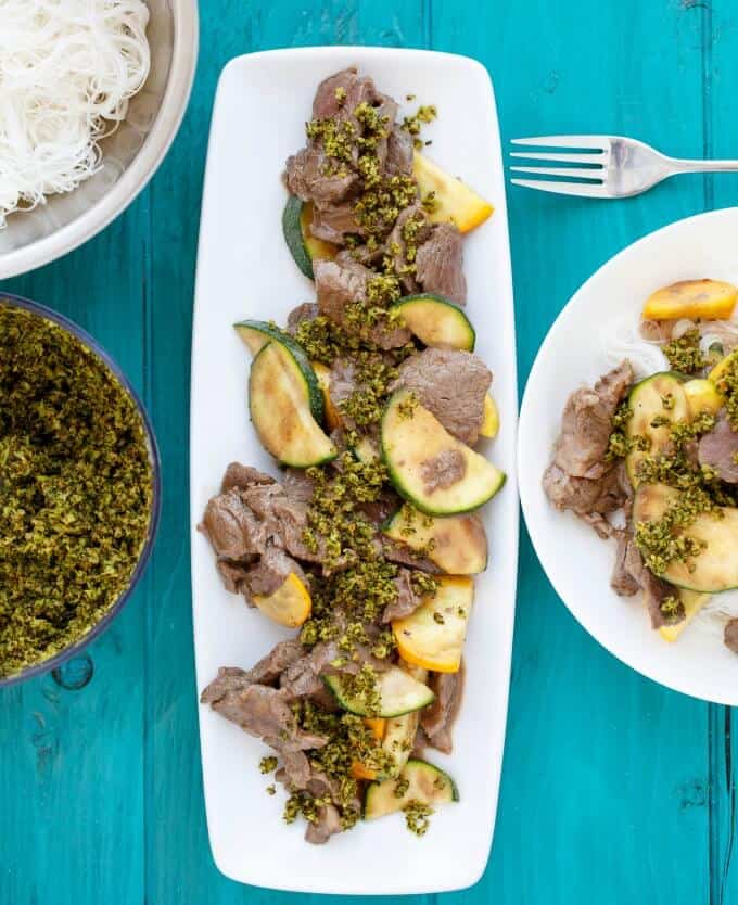 Beef and Zucchini Stir Fry with Roasted Broccolion white stray and plate with fork on blue table #beef