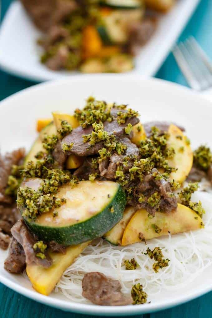 Beef and Zucchini Stir Fry with Roasted Broccoli on white plate on blue table#zucchini