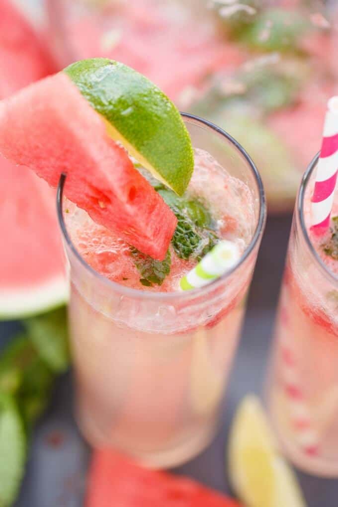 Watermelon Mojitos in glass cup with straw, lemon and lime slice