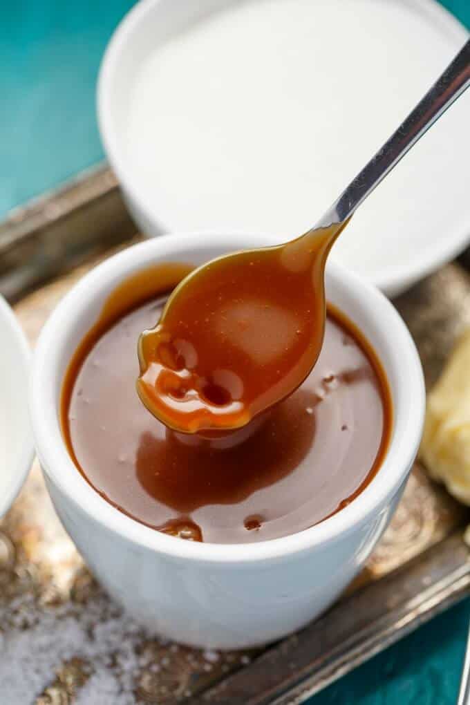 Dry Method Caramel Sauce: in white cup with spoon