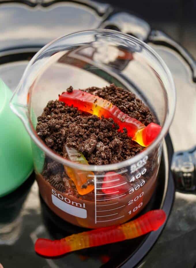 Homemade Worms and Dirt Dessert in glass jar on glass tray
