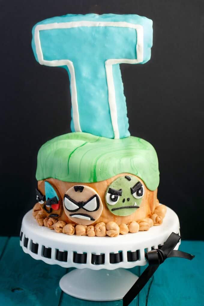 Teen Titans Go Cake on white tray on blue table