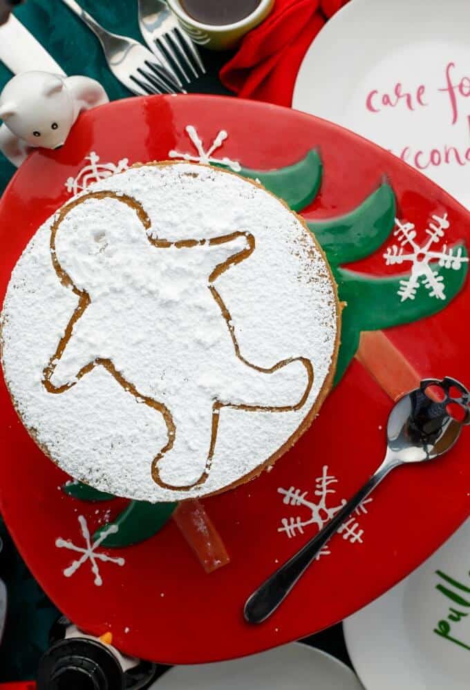 Gingerbread Cheesecake on christmas themed tray with spoon, forks and plates