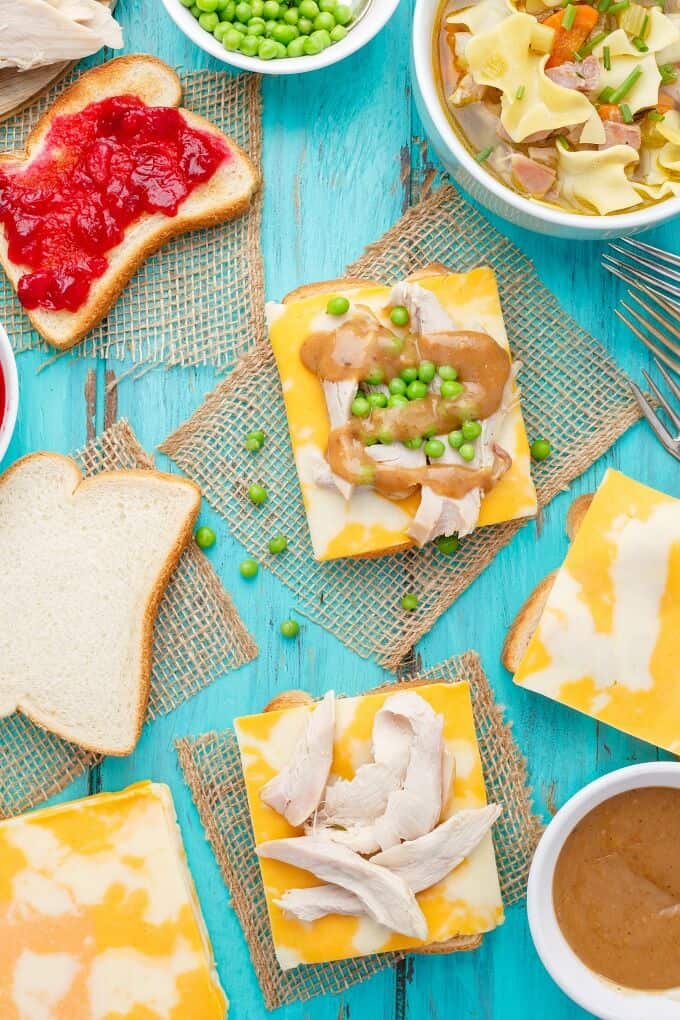 Open-Faced Turkey Sandwiches (Using Leftover Turkey) with peas on blue table, process of making