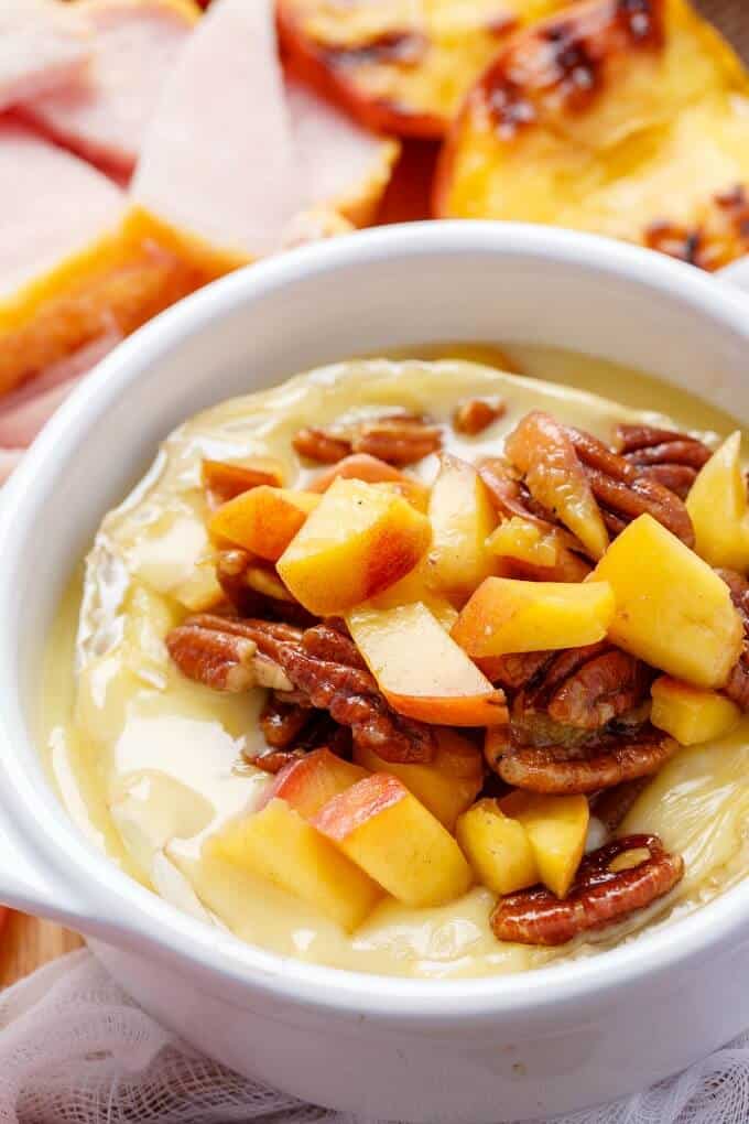 Grilled Maple-Butter Peach Camembert with Maple Pecans & Peameal Bacon in white bowl