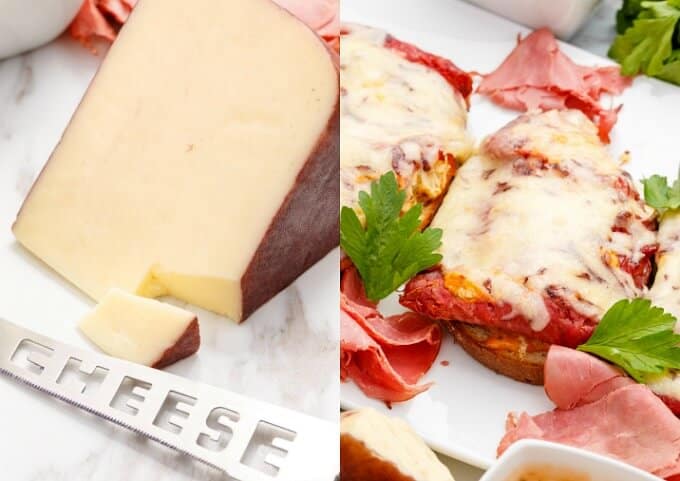 Open-Faced Reuben Sandwiches on white gray tray with herbs. Cheese on white gray background