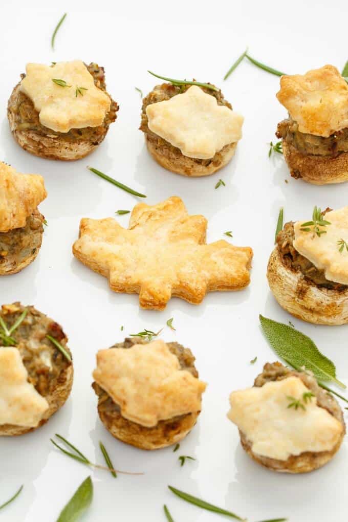 Tourtiere Stuffed Mushrooms on white tray with herbs