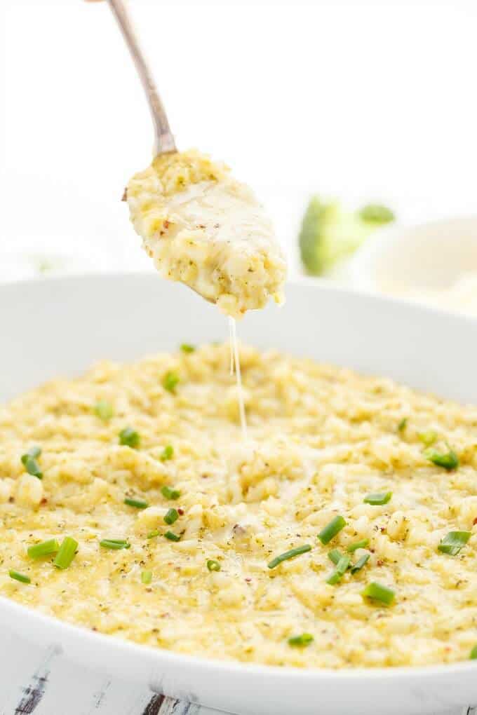 Cheesy Broccoli-Cauliflower Risotto in white bowl picked by spoon