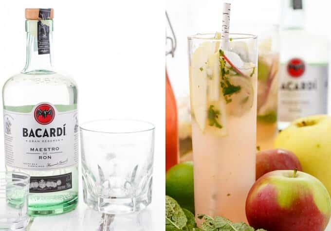 Apple Mojitos in glass cup with straw and apples, limes around. Bacardi liquior in glass bottle.