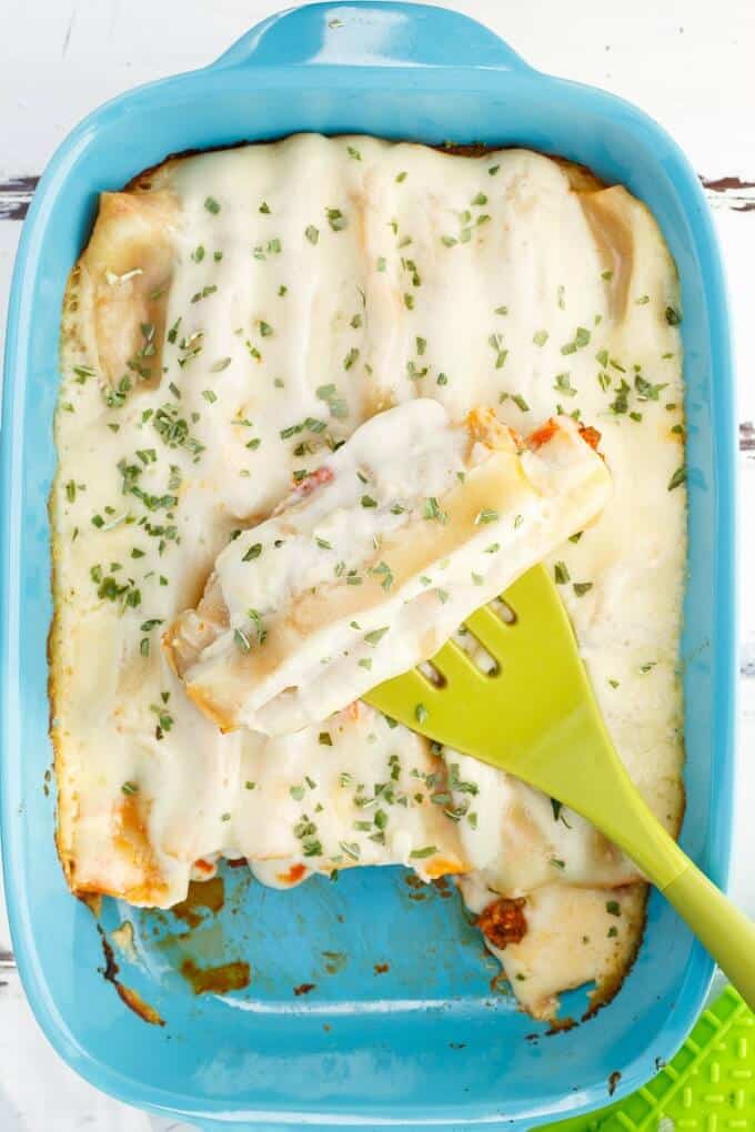 Turkey-Lentil Cannelloni in blue casserole with green spatula