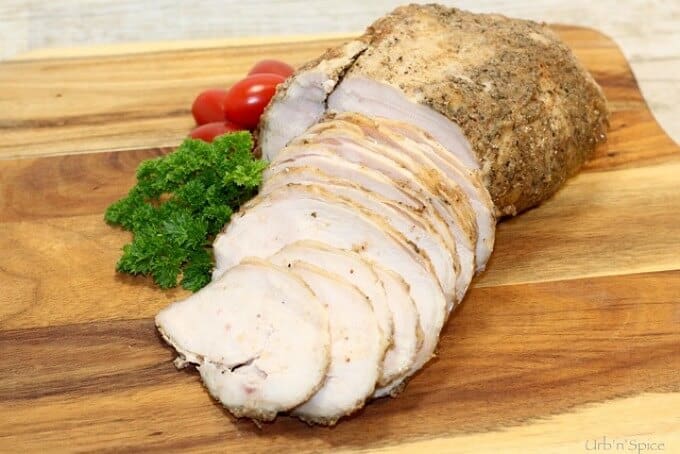 Spice turkey deli meat with vegetables on wooden pad