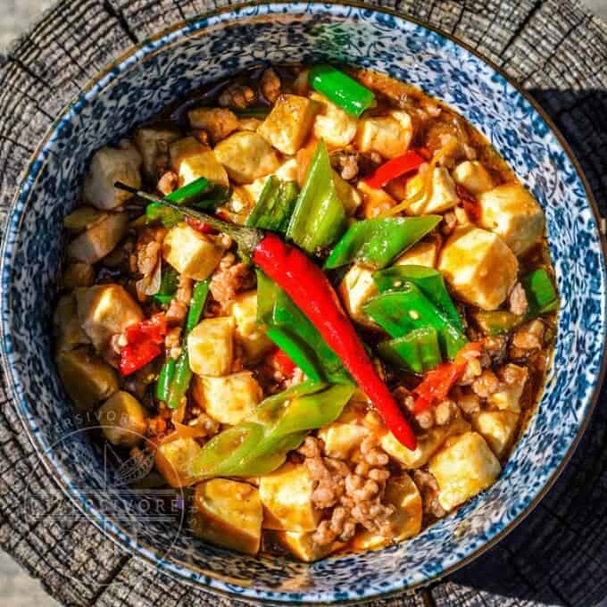 Mapo tofu in blue bowl with peppers