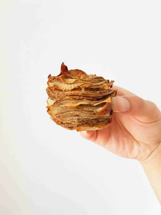 Parmesan potato stack held by hand